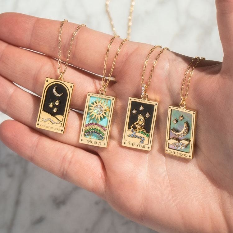 four tarot card-inspired necklaces