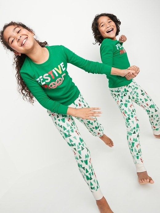 Kid models wearing the pajamas in the elf design