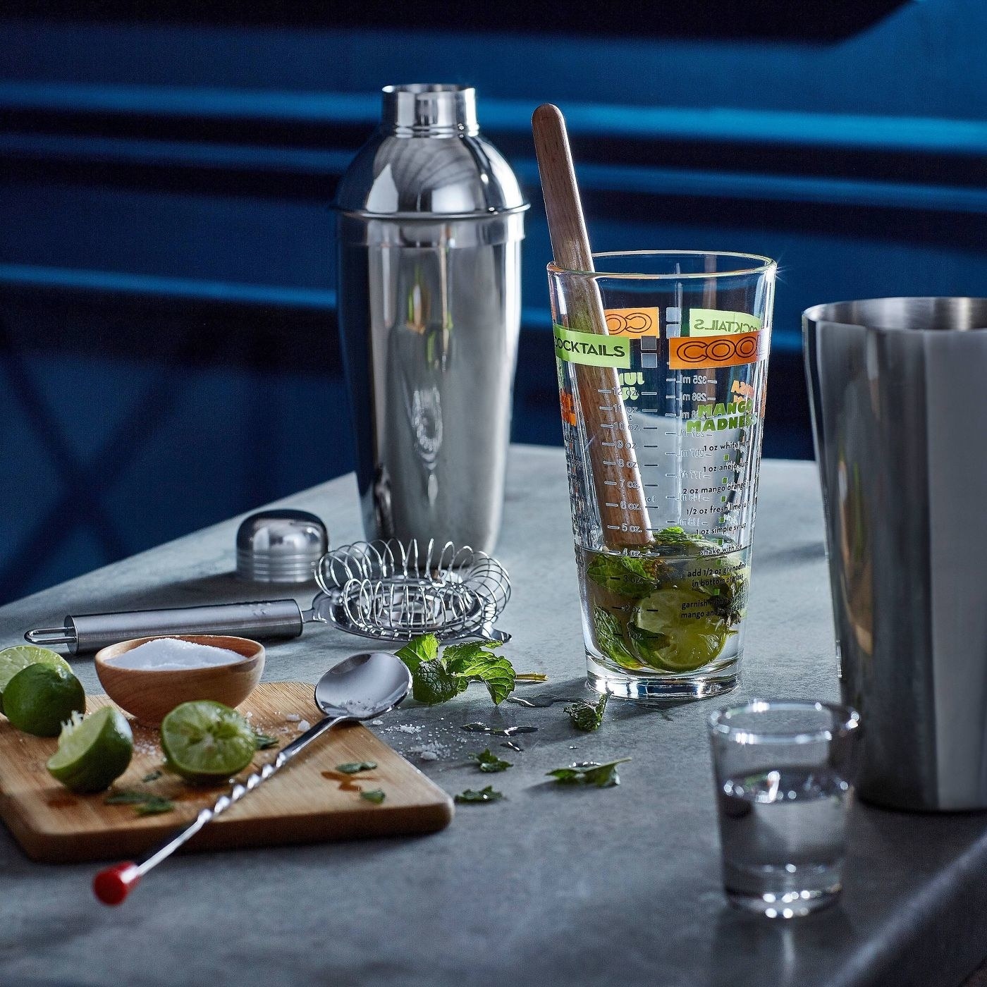A tabletop with the makings of a mojito, using the 9-piece cocktail bar set