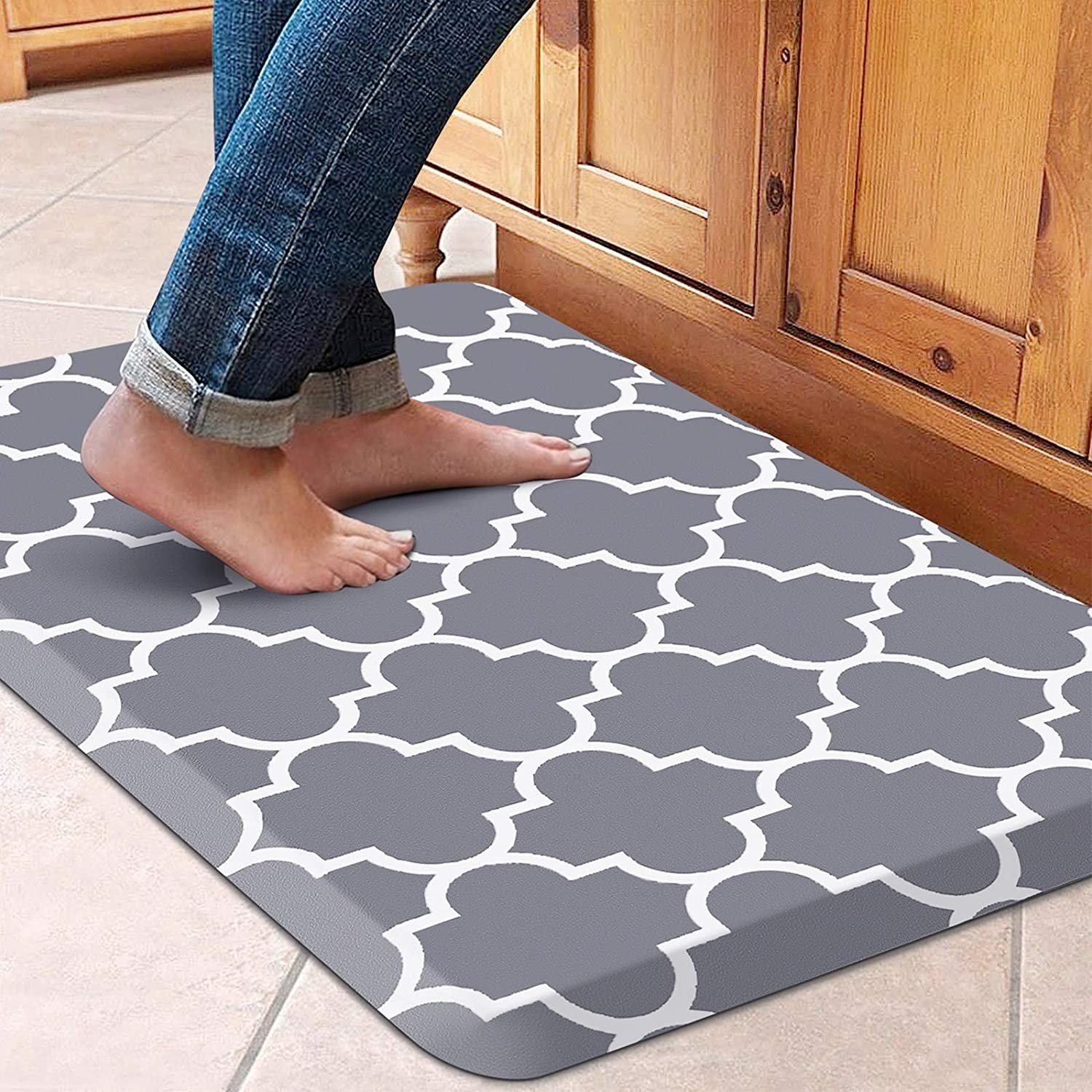 Model standing barefoot on the gray kitchen mat