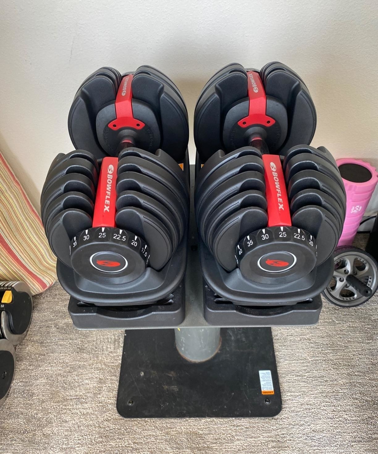 Review image of black and red adjustable dumbbells on a stand