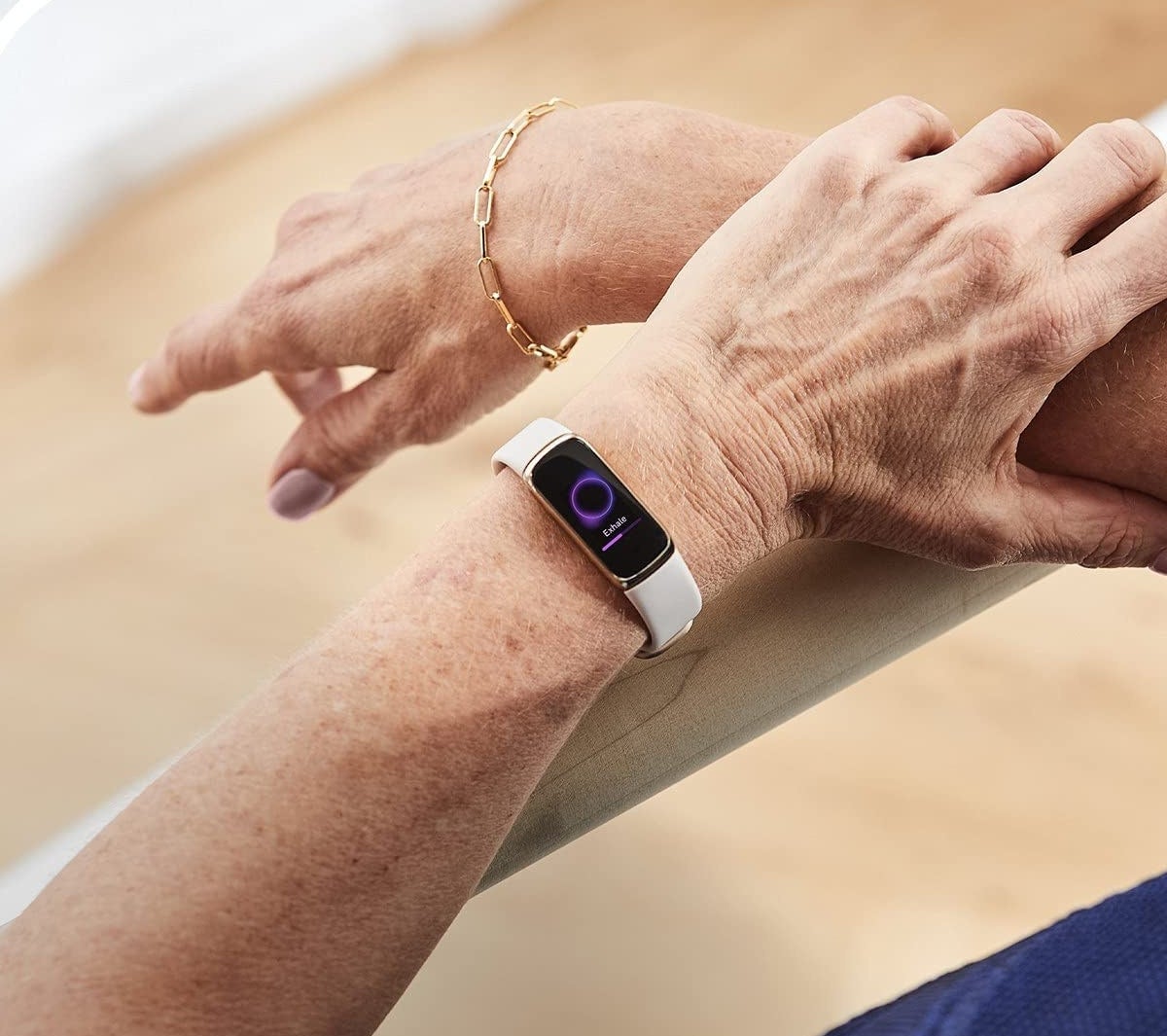 A person wearing the FitBit on their wrist