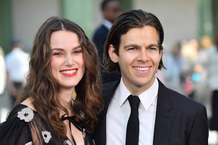 The couple smile while at a red carpet event