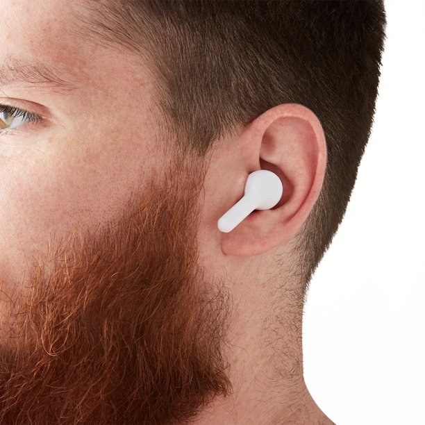 a model wearing the white earbud