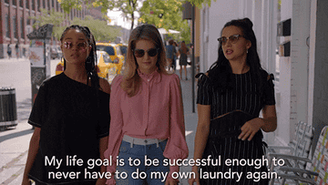 GIF three women walking saying my life goal is to be successful enough to never have to do my own laundry again