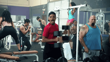 Chance the Rapper dancing with weights in his hands at a gym