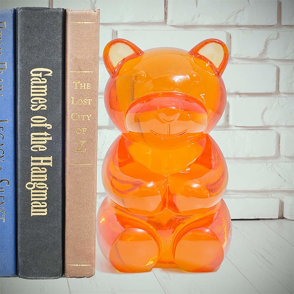 a giant orange gummy bear bookend