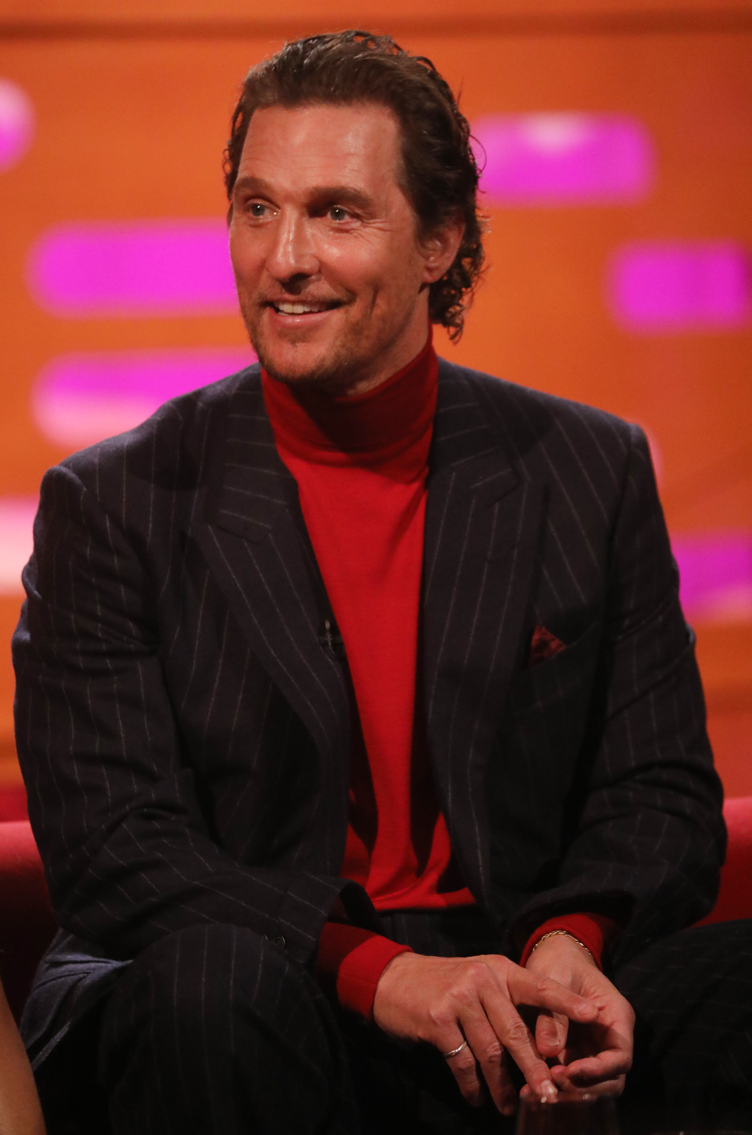 Matthew sitting during a talk show interview