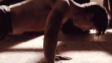 A shirtless man doing pushups