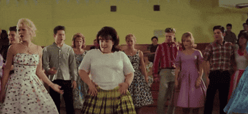 &quot;Hairspray&quot; – Tracy Turnblad in the middle of the dance floor dancing, with people clapping her on.