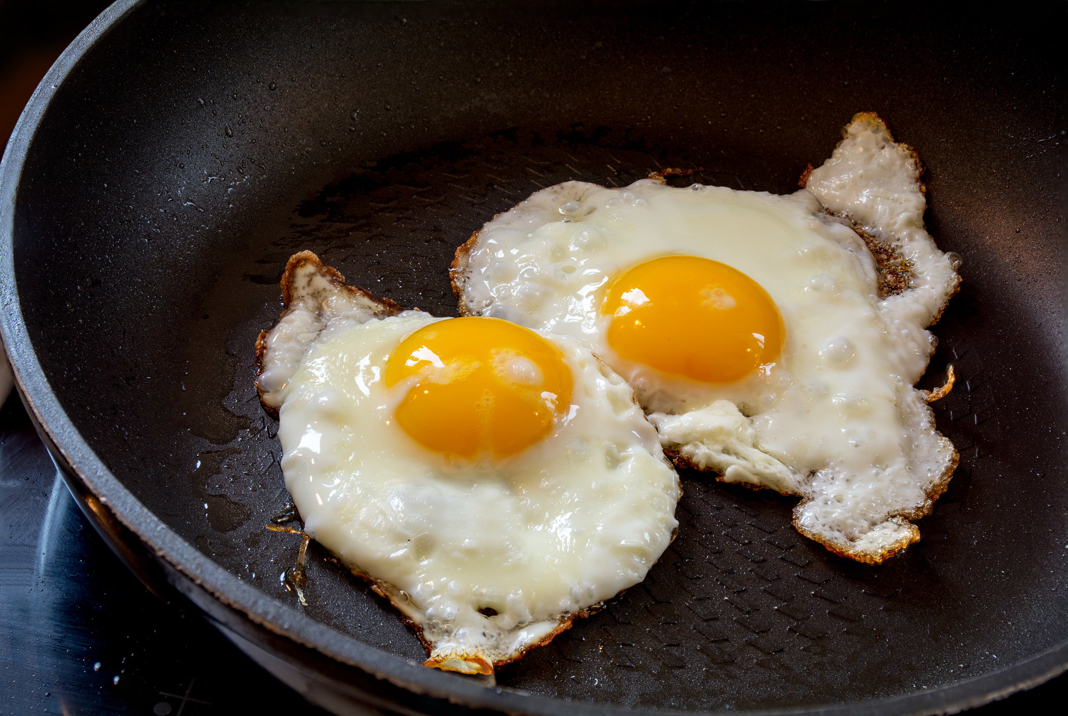 Two fried eggs in a pan.