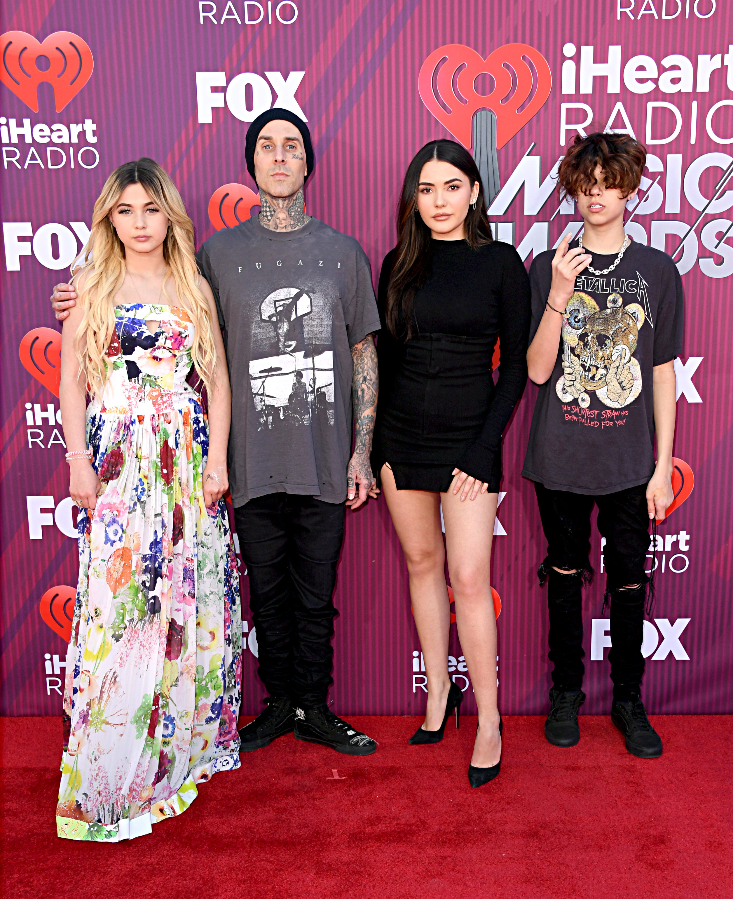 Travis poses with his kids on the red carpet at the I Heart Radio Awards