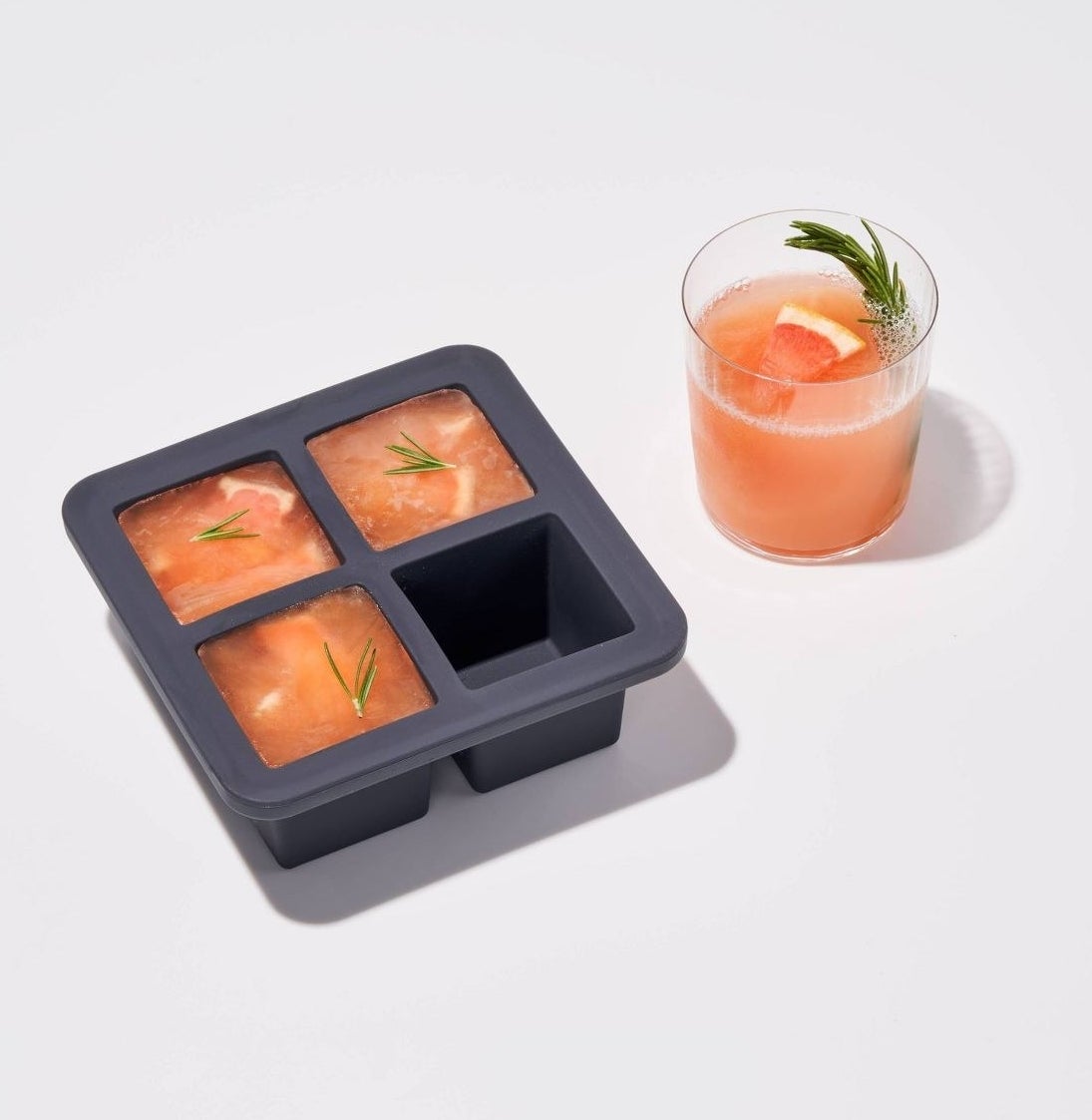 A cocktail mix is frozen in large square ice cube trays