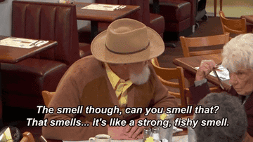 Gordon Ramsay disguised as an older man sitting at a restaurant guests describing a fishy smell