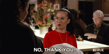 Ali Wong in a restaurant telling a staff member &quot;no thank you&quot;