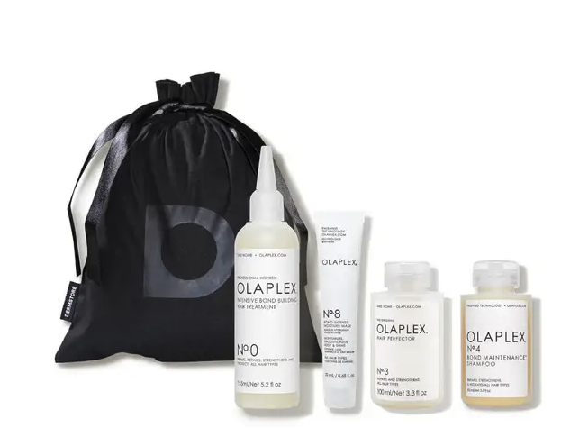 the four bottles included in the hair treatment kit and a Dermstore bag