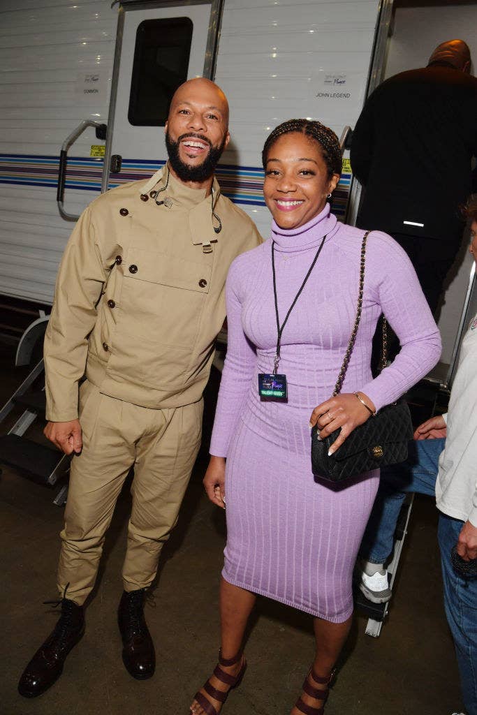 The couple smiling as they stand side by side