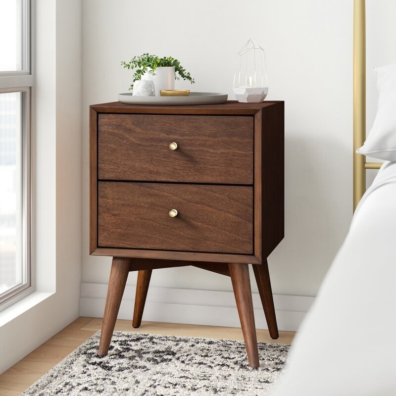 Walnut-colored nightstand shown in a bedroom