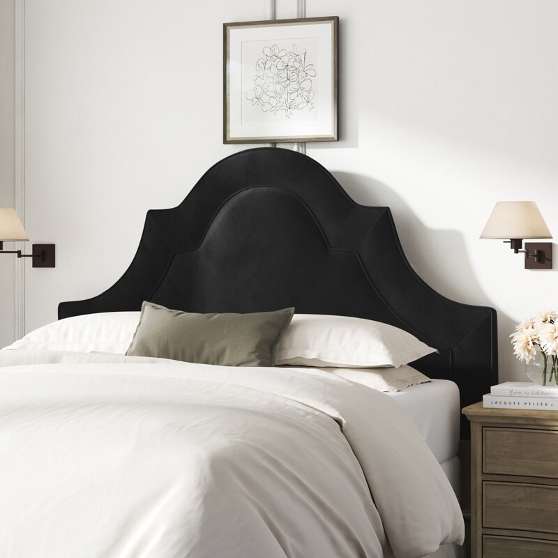 Black headboard shown in a bedroom