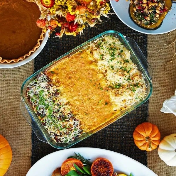 A dish of vegetable gratin 3 ways set on a table.