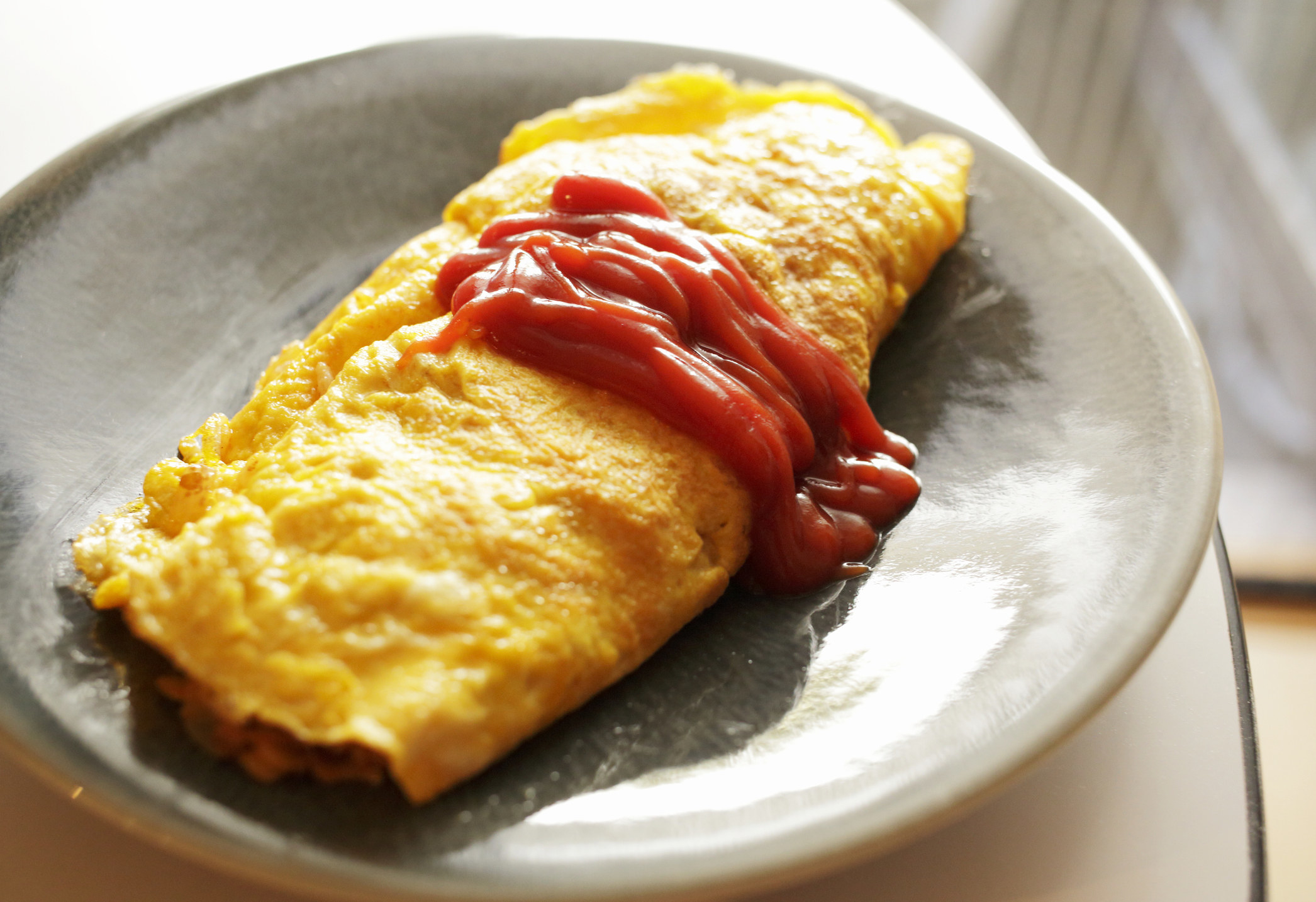An omelet with ketchup.
