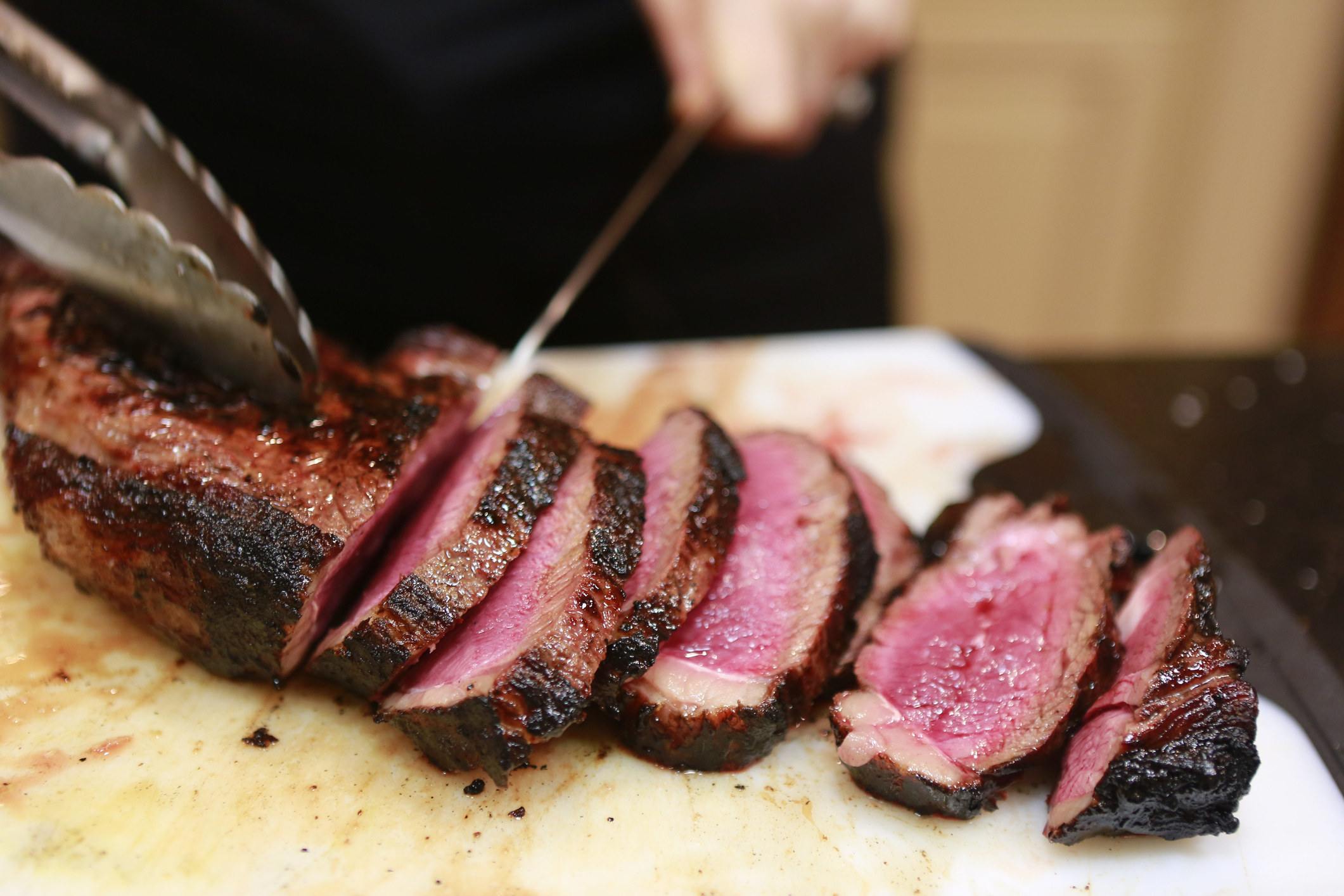 Slicing rare steak.