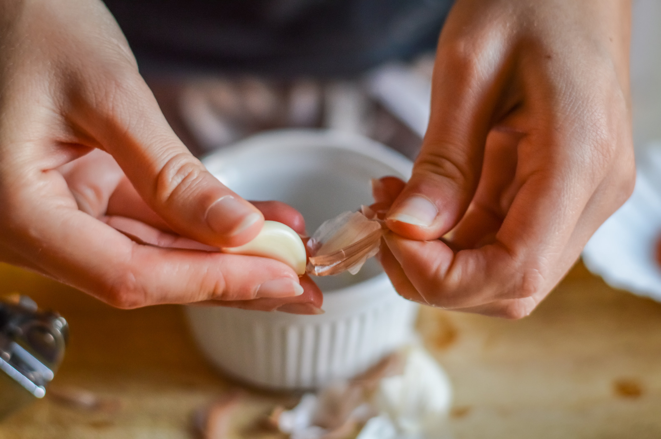 Peeling a clove of garlic.