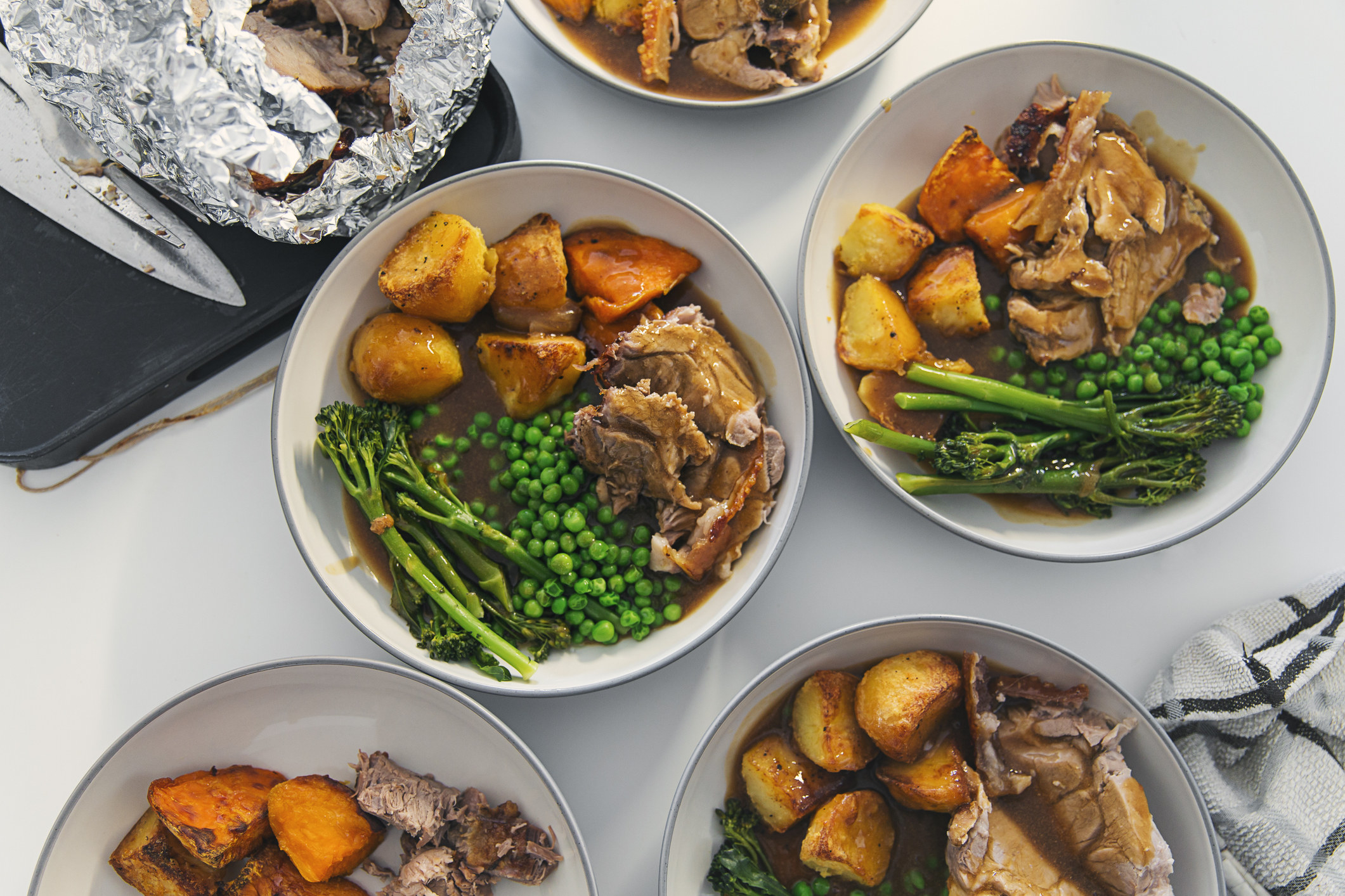 Plates of pot roast with vegetables.