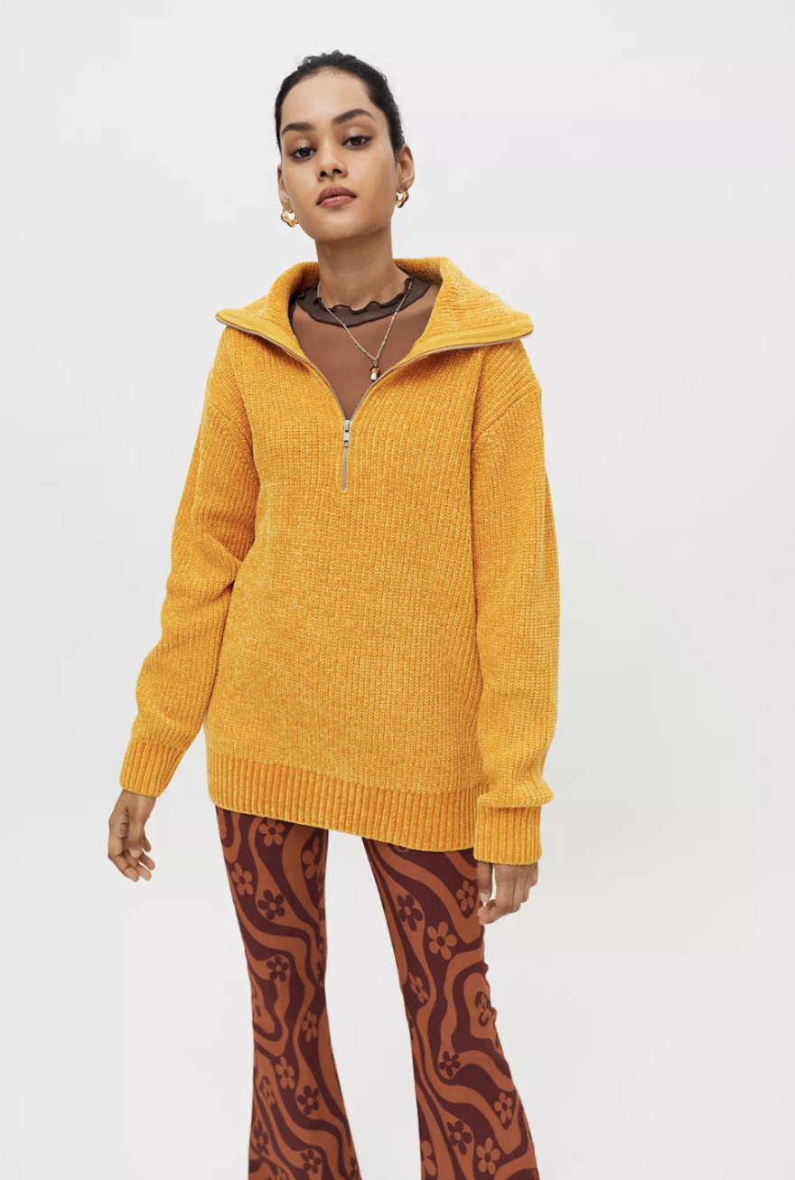 a model in a yellow half zip sweater