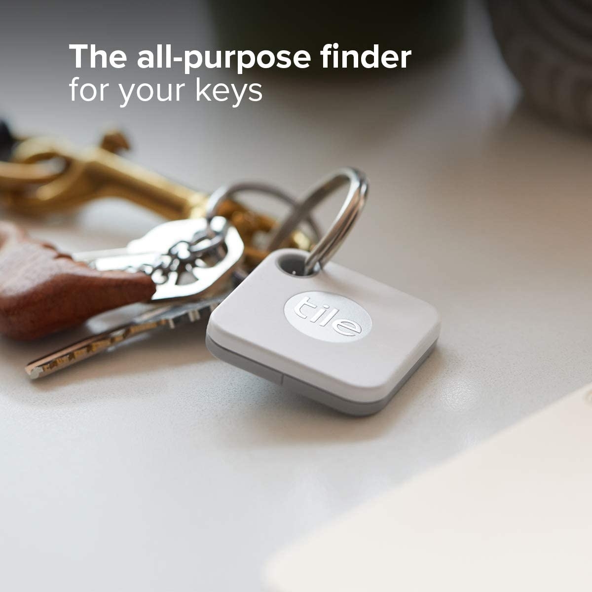 A square Bluetooth tracker attached to a ring of keys