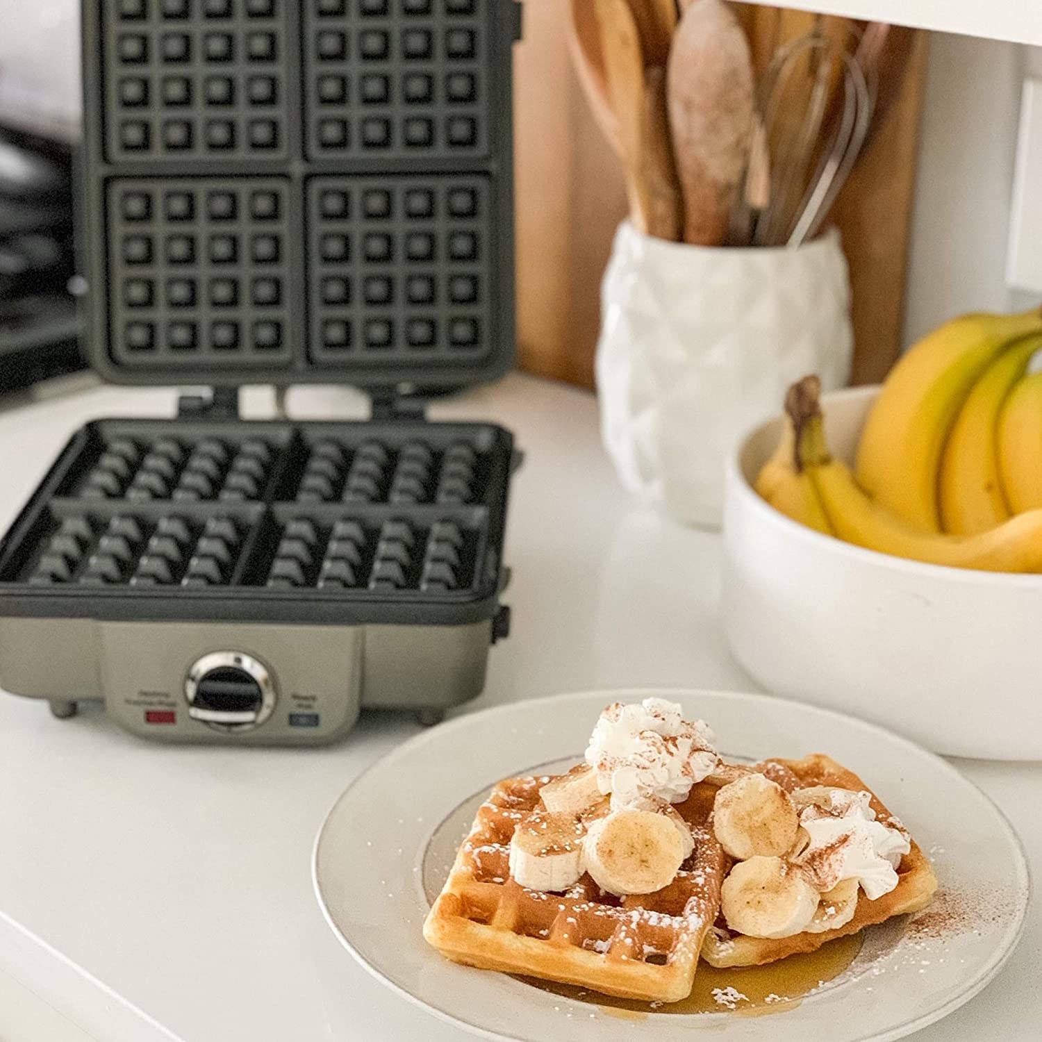 Waffles on a plate in front of the waffle maker