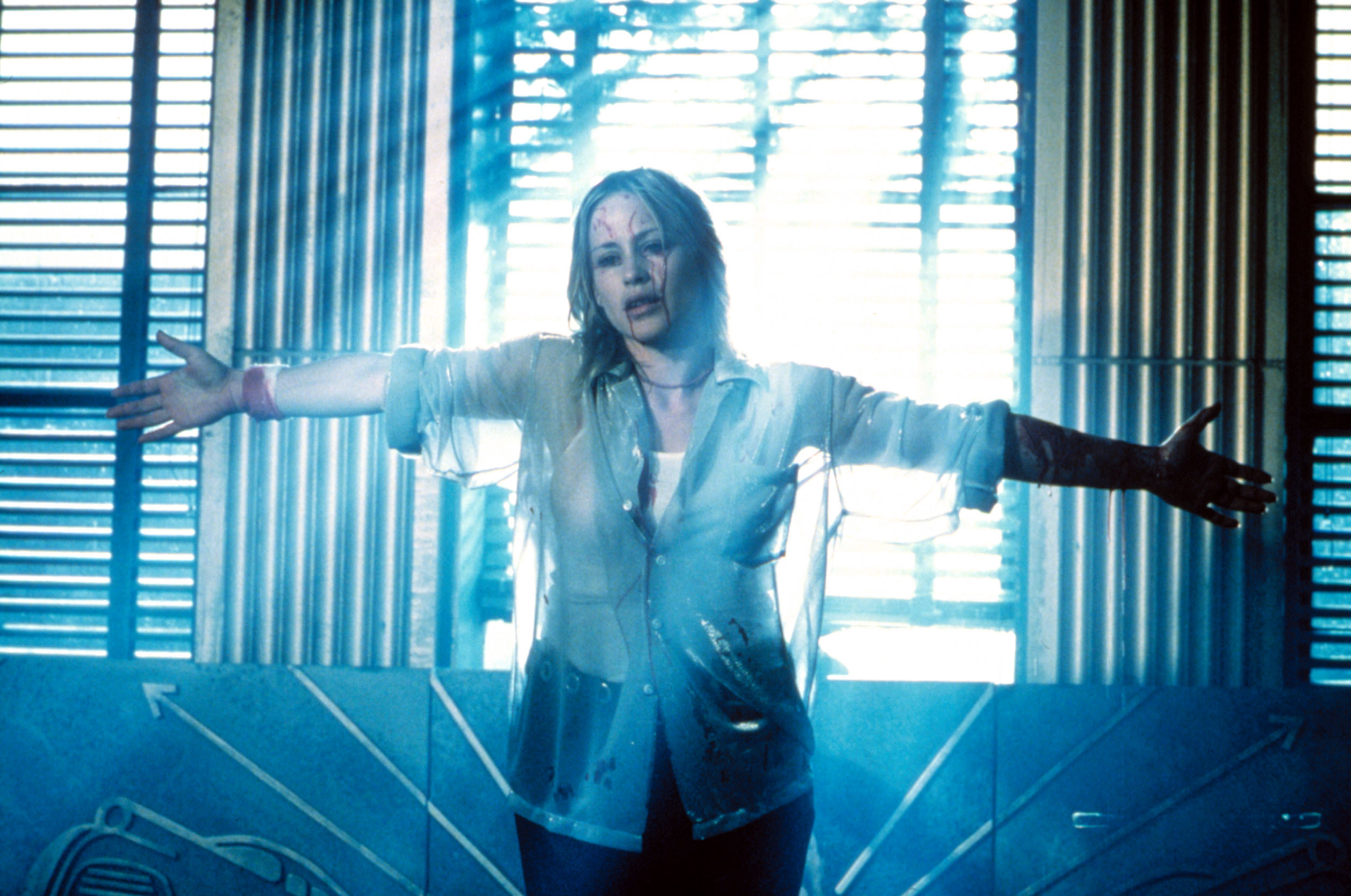 Patricia Arquette as Frankie, standing with her arms out and blood dripping down her face
