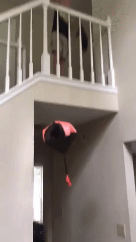 Reviewer tossing the red parachute from the top of the stairs