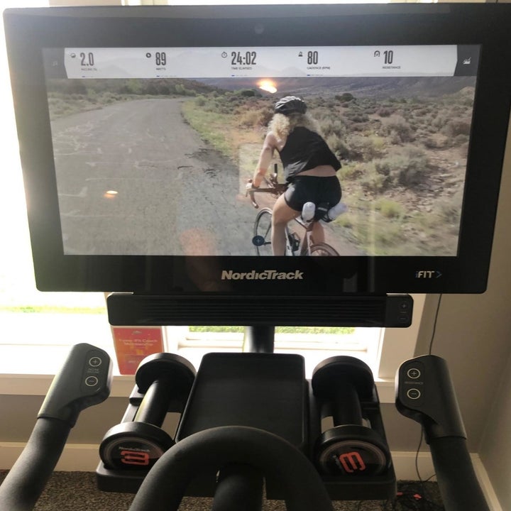 reviewer photo of the screen showing an instructor on a guided bike ride