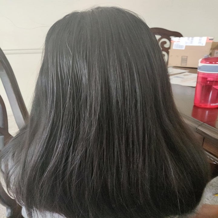 reviewer's smooth and tangle-free hair after using the spray and brushing it
