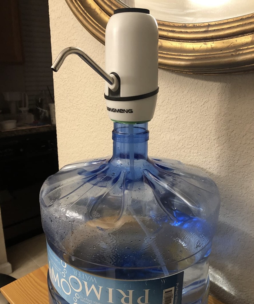 reviewer&#x27;s water pump attached to a five-gallon water jug