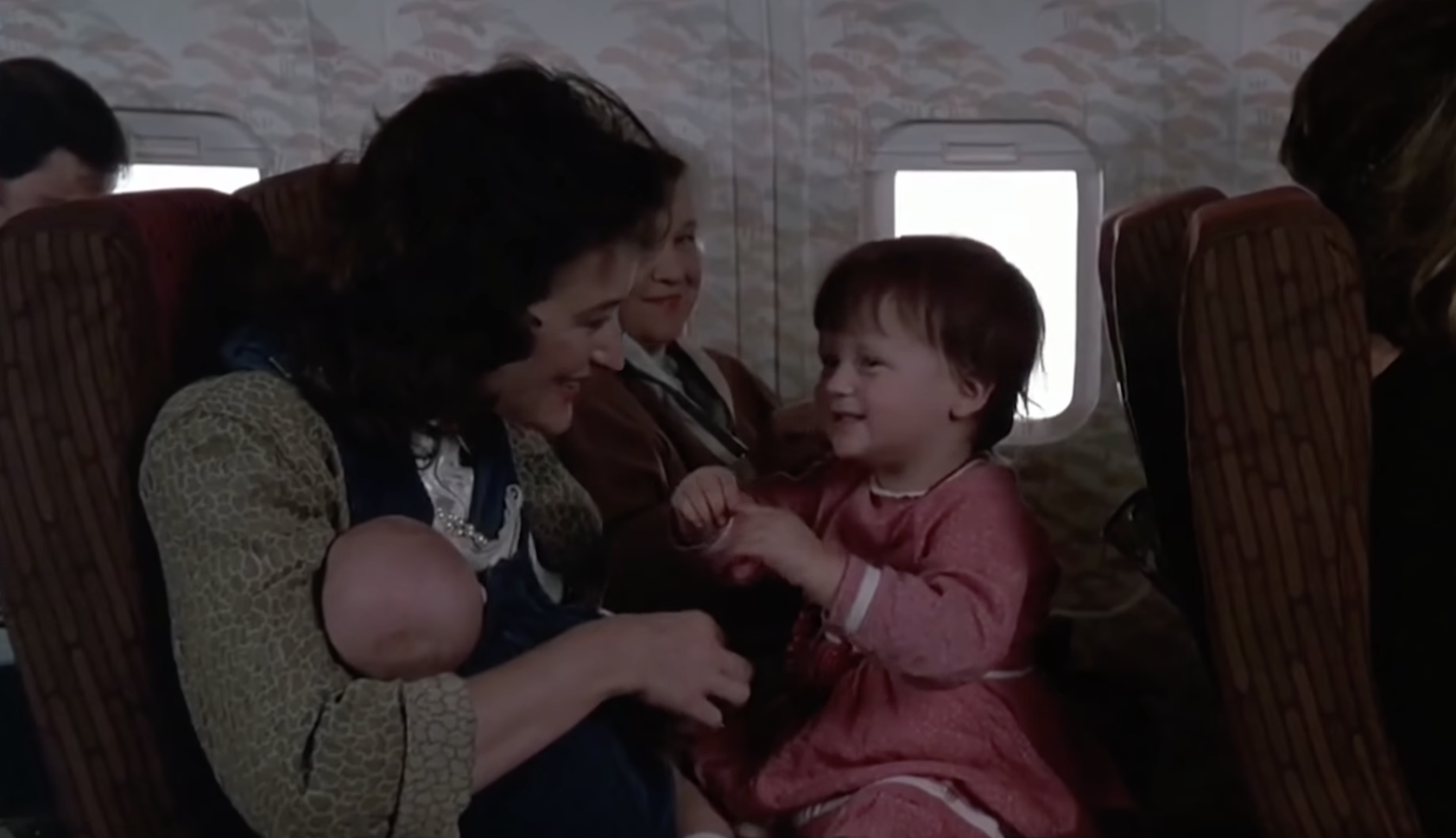 Streep holding a baby Mamie on her lap on an airplane in &quot;Heartburn&quot;
