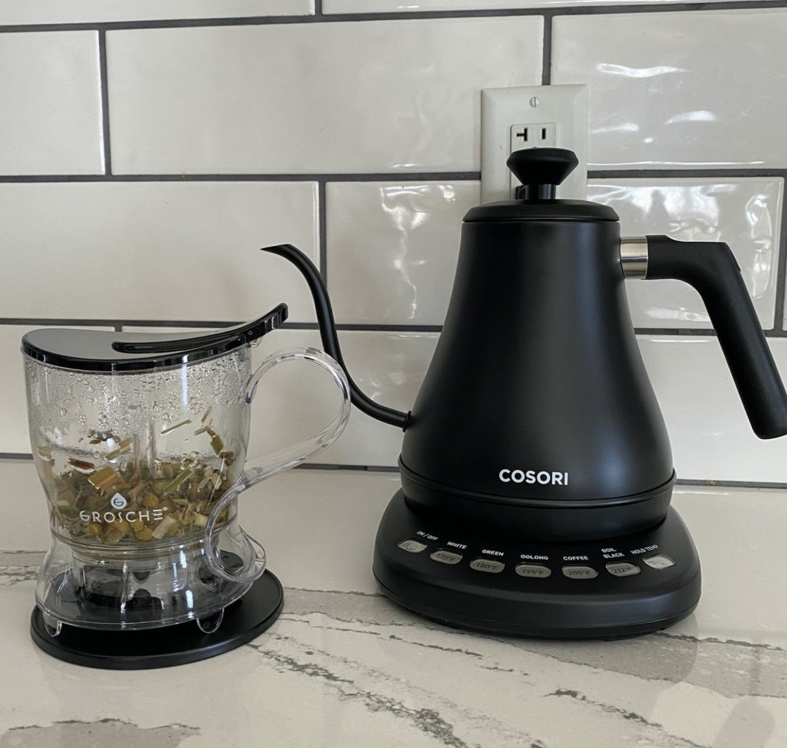 the electric kettle next to a tea cup