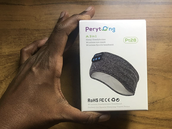 A customer review photo of them holding the box of the headband