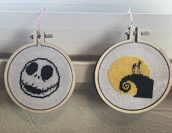 A customer review photo of three completed cross-stitch patterns