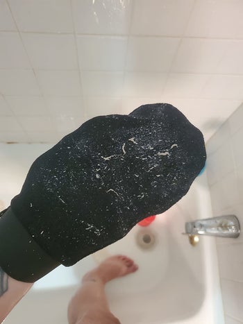 a reviewer photo of the mitt covered in dead skin