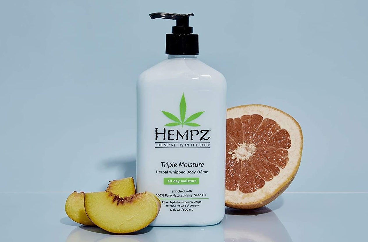 the moisturizer pump bottle next to slices of peach and grapefruit
