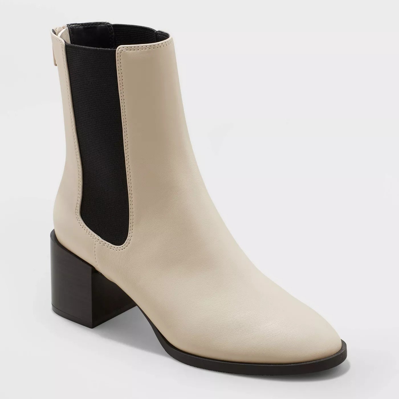 The bone colored boot with black heel, and black side detailing