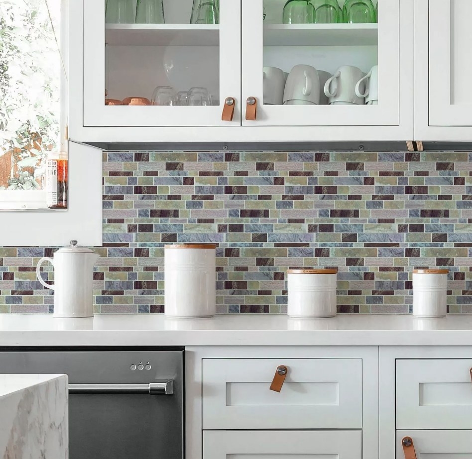 A blue/green/brown peel and stick backsplash in a kitchen
