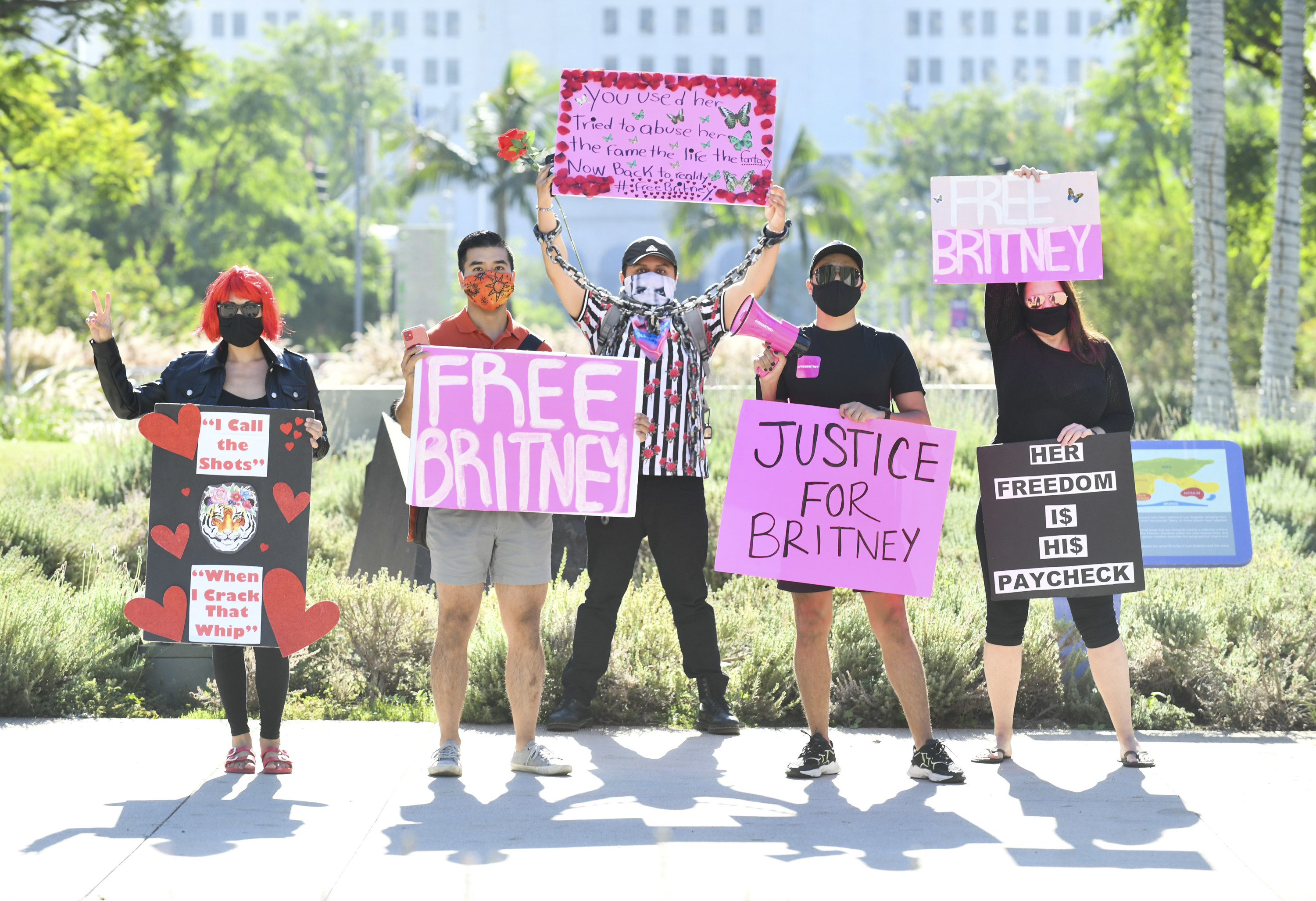 Protesters carry signs that read &quot;Free Britney,&quot; &quot;Justice for Britney&quot; and &quot;Her Freedom Is His Paycheck&quot;