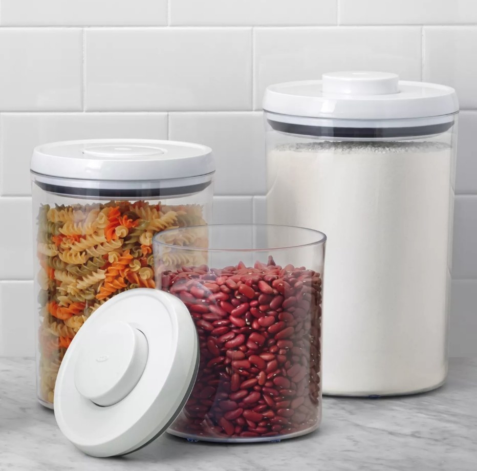3 airtight canisters filled with pasta, flour, and beans