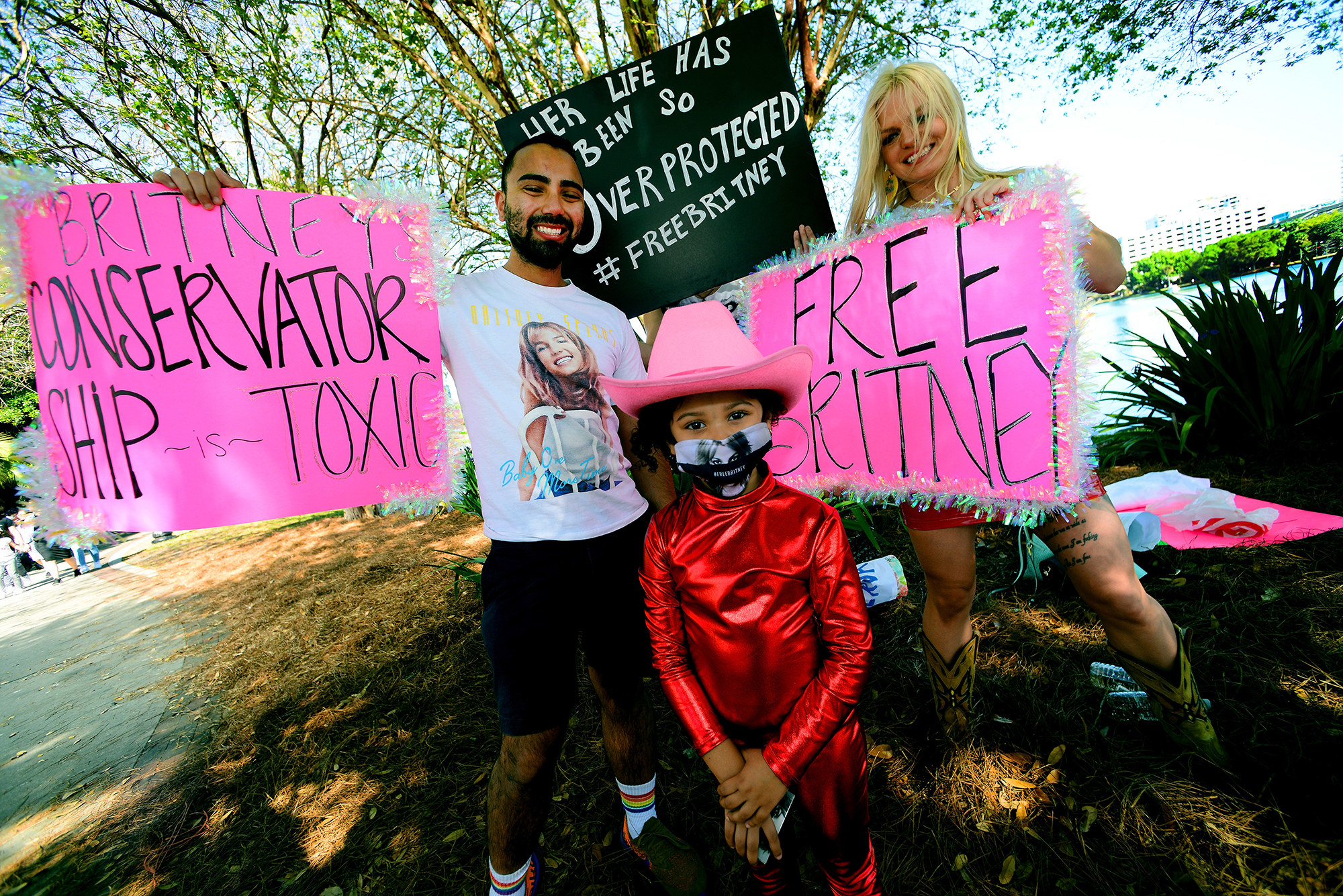Protesters hold signs that read &quot;Britney&#x27;s conservatorship is toxic&quot; and &quot;Her life has been so overprotected&quot;