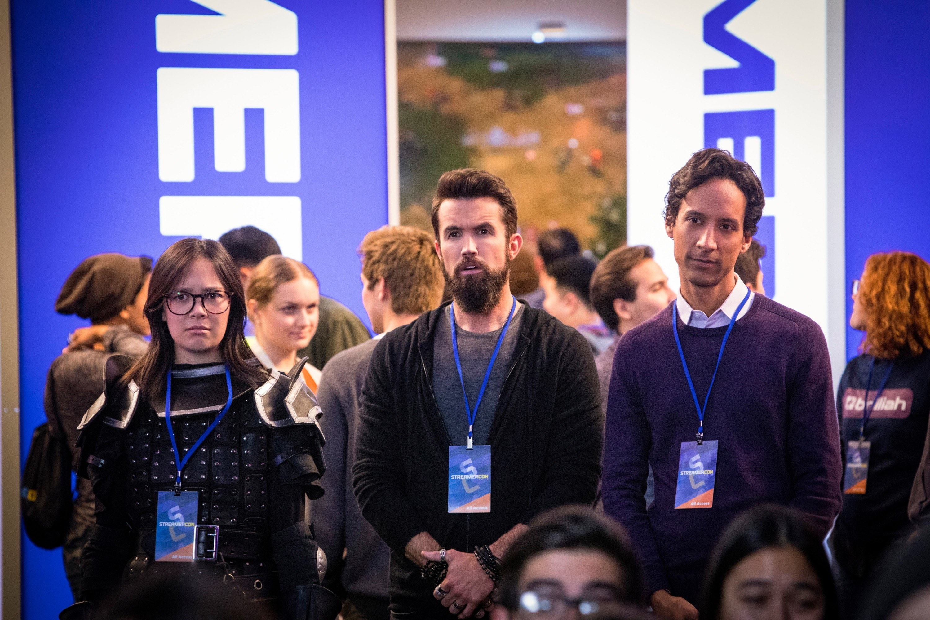 Charlotte Nicdao, Rob McElhenney, and Danny Pudi stand at a convention