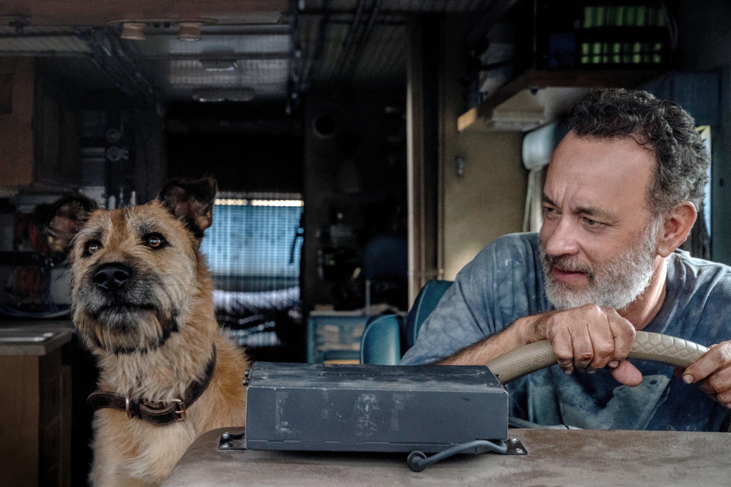 Tom Hanks sits in an RV with his dog