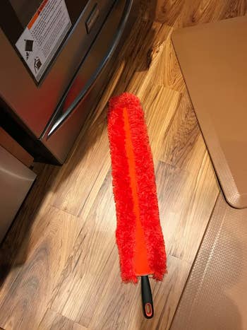 reviewer showing the length of the red duster